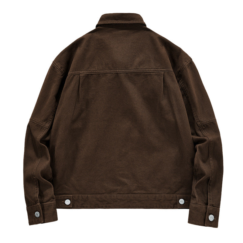 Men's short worker jacket made of heavy twill with applied flap pockets, slanted side pockets, and reinforced seams.