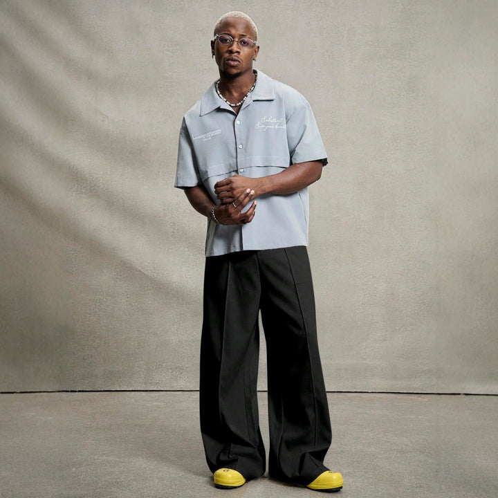 Men's wide pleated pants with high waistband, precise creases, and side inset pockets Mune Fashion