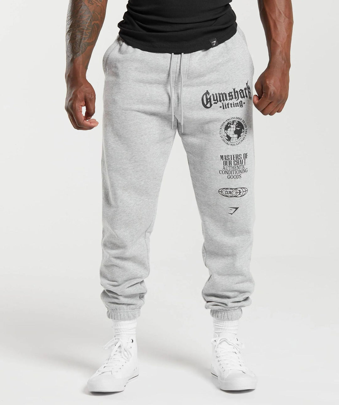 Men's tapered cotton fleece sweatpants with an elastic drawstring waistband, ribbed leg openings, and large logo print Mune Fashion