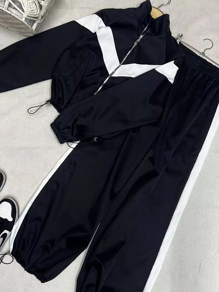 Women's tailored zip training set with chevron insert, drawstring hem, and high-cut jogging pants Mune Fashion