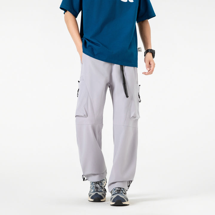 Men's wide cargo pants in baggy style with drawstring waistband, large flap pockets, and adjustable leg openings Drune