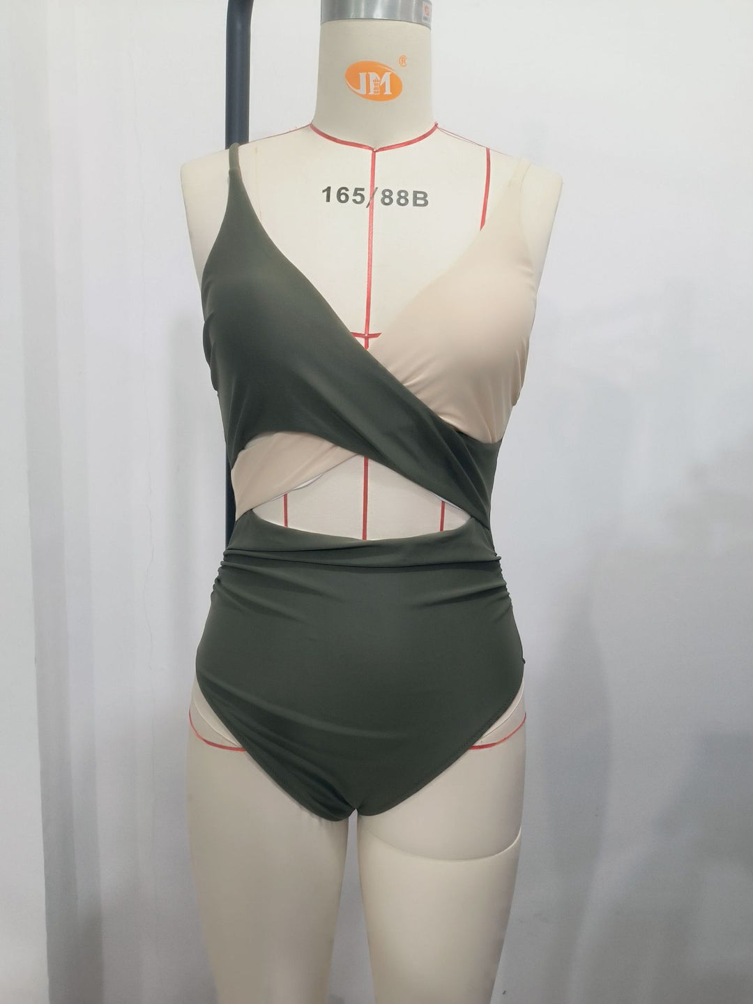 Ladies modern designed one-piece swimsuit with asymmetrical cut and wrap details Mune Fashion