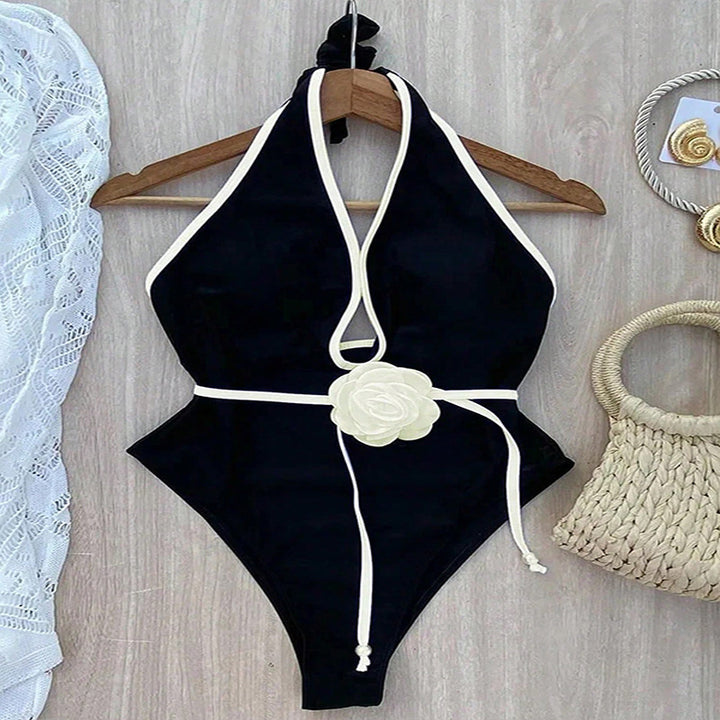 Women's elegant one-piece swimsuit with sophisticated cut-outs and floral belt Mune Fashion