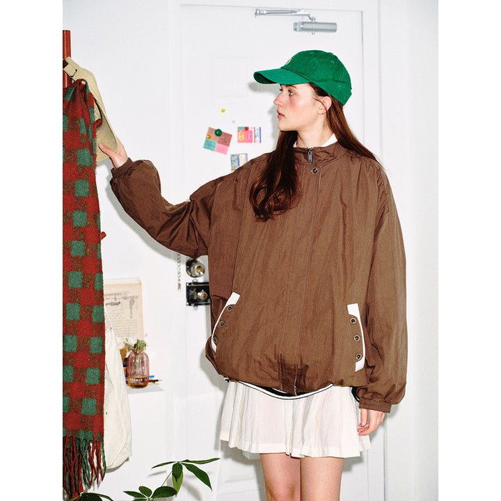 Unisex short-cut lightweight windbreaker jacket with standing collar, concealed zipper, and contrasting patch pockets Mune Fashion