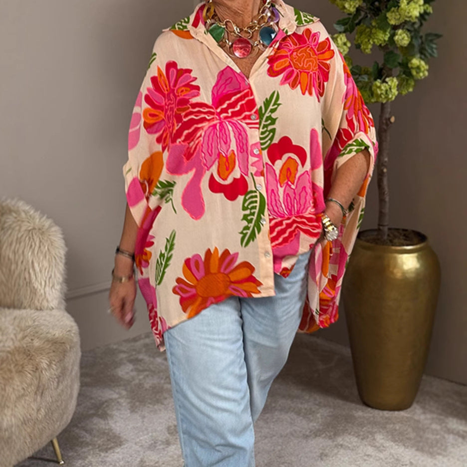 Women's airy oversized resort-style shirt blouse with large floral print and asymmetrical scalloped hem Mune Fashion