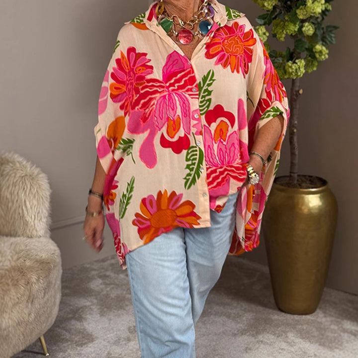 Women's airy oversized resort-style shirt blouse with large floral print and asymmetrical scalloped hem Mune Fashion