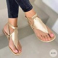 Women’s flat T-strap thong sandals with adjustable ankle strap and decorative floral appliqué in faux leather Mune Fashion