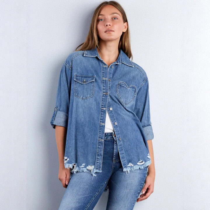 Women's casual denim shirt jacket oversized with patch chest pockets, heart embroidery detail, and frayed hem Mune Fashion