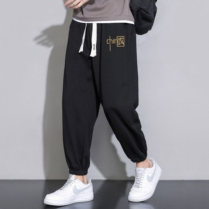 Men's loose fitting sweatpants with drawstring, elastic cuffs, and side pockets Mune Fashion