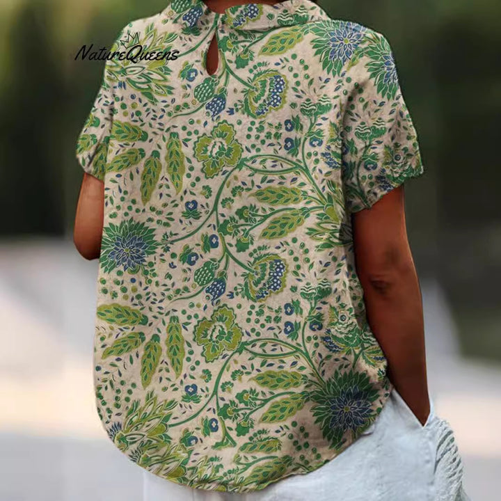 Women's casual short-sleeve blouse with V-neck, rounded hem, and botanical all-over print Mune Fashion