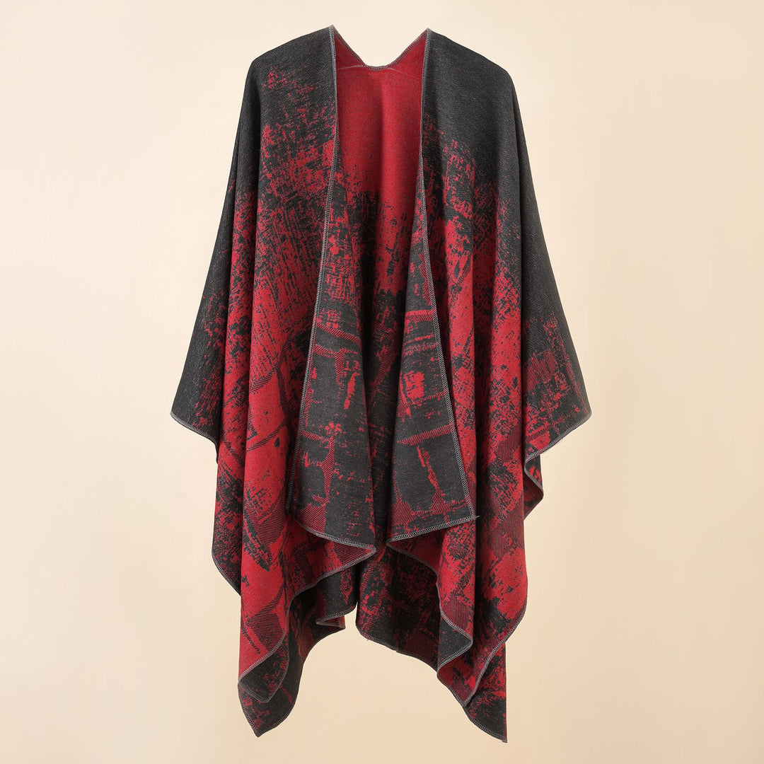 Women's wool blend cape with graphic jacquard, open kimono fall, and soft draping.