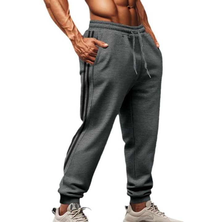 Men's sporty jogging pants with side contrast stripes, elastic drawstring waistband, and ribbed leg endings Mune Fashion