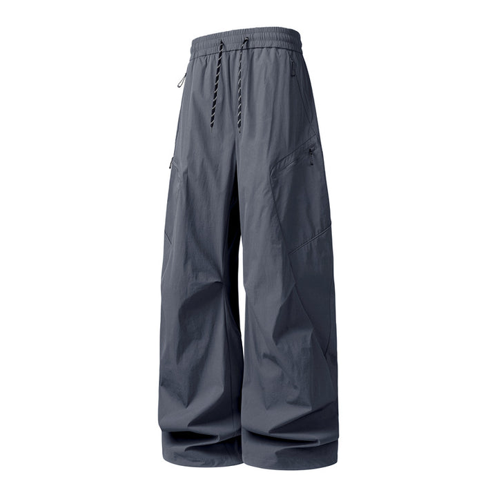 Men's Oversize Utility Cargo Pants made of lightweight nylon with elastic drawstring waistband, side zipper pockets & wide balloon silhouette Mune Fashion