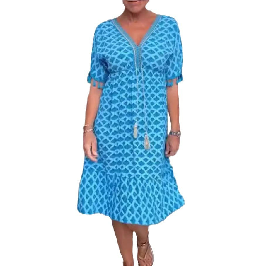 Women's casual midi dress in kaftan style with V-neck, tassel band, gathered empire seam, and fringe sleeves Mune Fashion