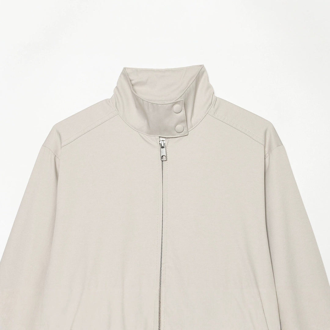 Women's short cut windbreaker with standing collar, press button placket, and elastic hem Mune Fashion