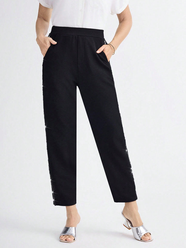 Women Elegant straight-cut fabric pants with elastic waistband and side glitter trim Mune Fashion