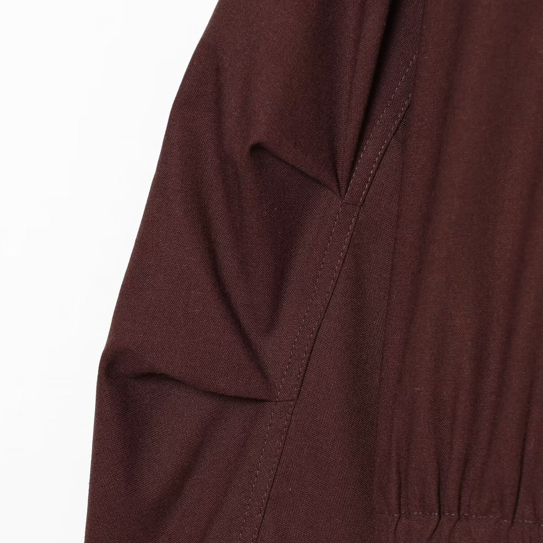 Women's short bomber-style jacket with high funnel collar, concealed zipper, and flap pockets Mune Fashion