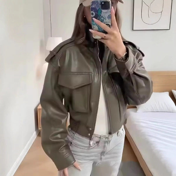 Women's short-cut military-inspired faux leather jacket with high stand collar, flap pockets, shoulder epaulets, and ribbed cuff Mune Fashion