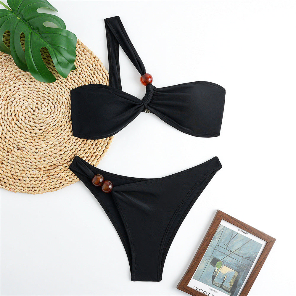 Women's bikini set with asymmetric halter neck and decorative pants buttons Mune Fashion