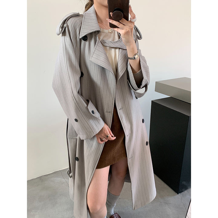 Women's pinstripe trench coat with boxy silhouette, shoulder patches, and concealed tie belt Mune Fashion