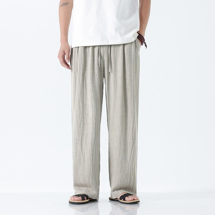 Men's loose linen trousers with adjustable drawstring waistband, casual pleat look, and side pockets Mune Fashion