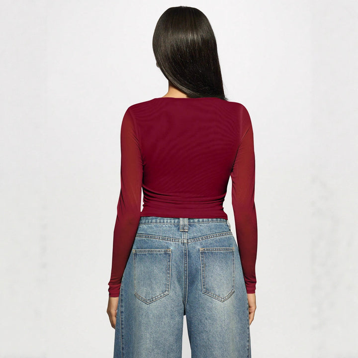 Women's fitted mesh top with rhinestone applications and boat neck Mune Fashion