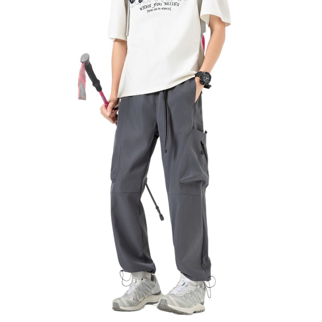 Men's wide cargo pants in baggy style with drawstring waistband, large flap pockets, and adjustable leg openings Drune