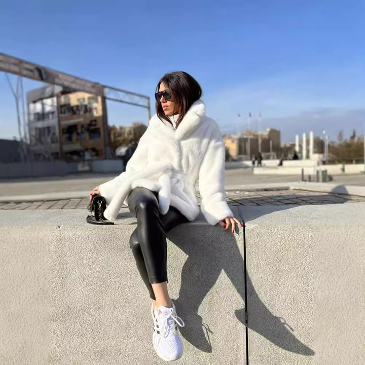 Ladies short coat made of luxurious faux fur with a waist belt and high shawl collar Mune Fashion