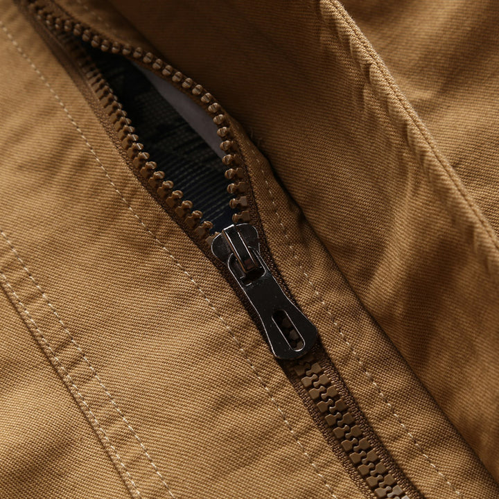 Men's lightweight canvas utility jacket with quilted lining, concealed two-way zipper, and elastic cuffs.