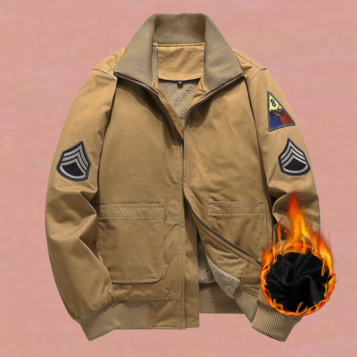 Men's military-inspired bomber jacket with applied patches, concealed zipper, and elastic cuffs.