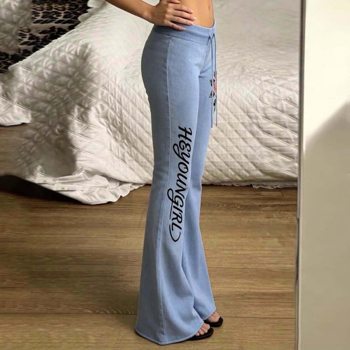 Women's casual jersey sweatpants with drawstring, floral side print, and statement lettering Mune Fashion