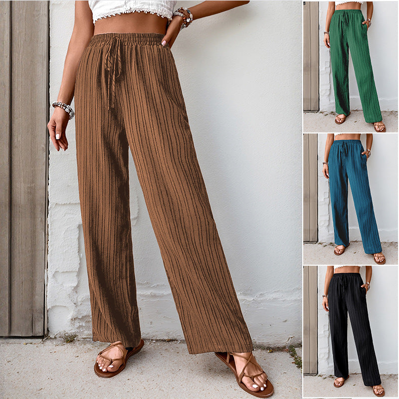 Women's loose summer trousers made from lightweight crinkle fabric with elastic waistband and drawstring.
