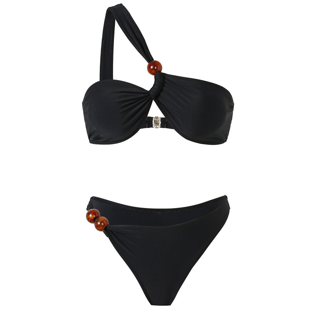 Women's bikini set with asymmetric halter neck and decorative pants buttons Mune Fashion