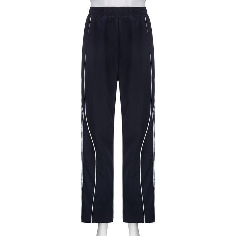 Ladies' sporty training pants with straight leg, elastic comfort waistband, and decorative side piping Mune Fashion