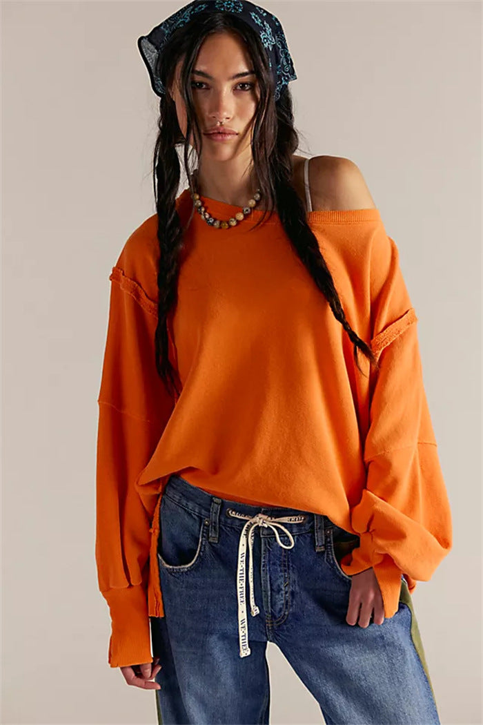 Women's oversized sweatshirt with balloon sleeves, open seam stitches, and side slits Mune Fashion
