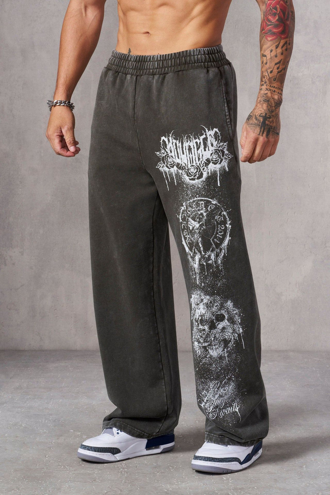 Men's baggy joggers with elastic waistband, side pockets and detailed skull and rose motif Mune Fashion
