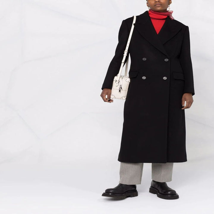 Women’s long coat in minimalist double-breasted style with tailored silhouette and flap pockets Mune Fashion