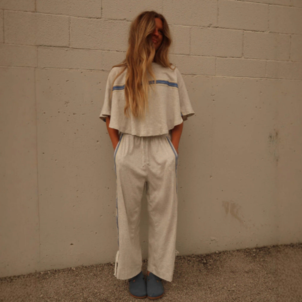 Ladies two-piece leisure ensemble with boxy ruffle top and wide cord pants with side decorative stripe Mune Fashion