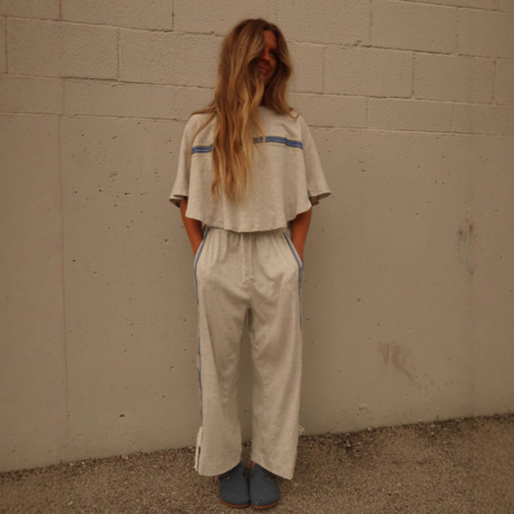 Ladies two-piece leisure ensemble with boxy ruffle top and wide cord pants with side decorative stripe Mune Fashion