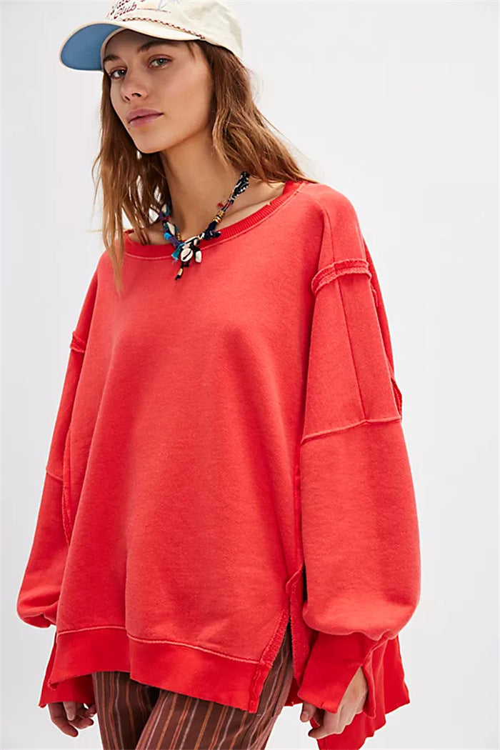 Women's oversized sweatshirt with balloon sleeves, open seam stitches, and side slits Mune Fashion