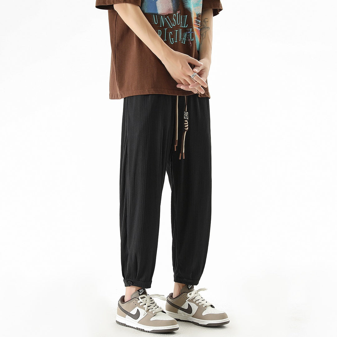 Men's loose-fitting leisure pants with drawstring, fine ribbed structure, and buttoned cuffs Mune Fashion