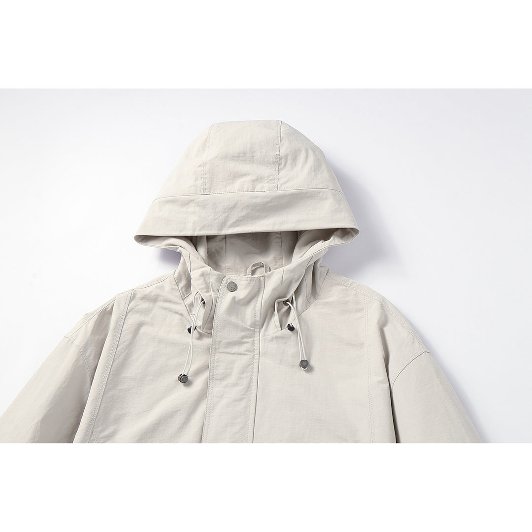 Unisex Light windproof hooded jacket in boxy cut with drawstring and concealed front Mune Fashion