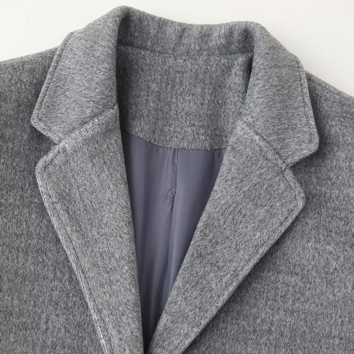 Women's short blazer coat made of wool blend with lapel collar, two-button closure, and patch pockets Mune Fashion