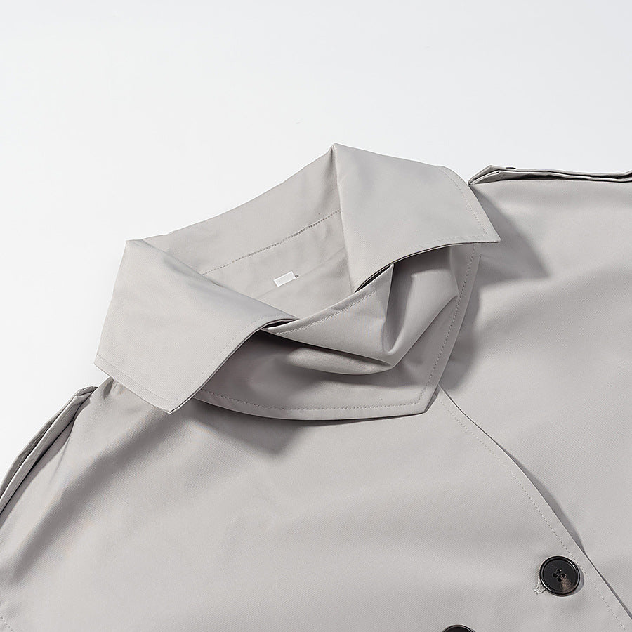 Women's short trench-style jacket with high standing collar, double-breasted front and waist belt Mune Fashion