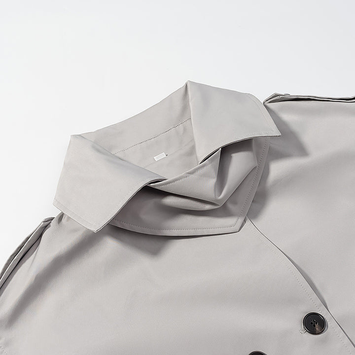 Women's short trench-style jacket with high standing collar, double-breasted front and waist belt Mune Fashion