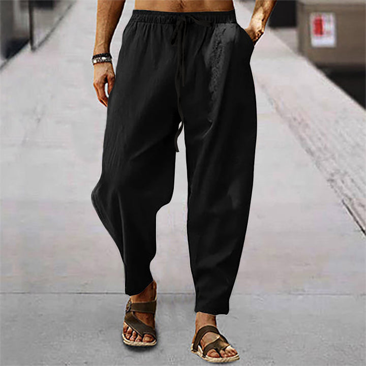 Men's loose linen casual pants with elastic tunnel drawstring waistband, low crotch, and tapered ankle length Mune Fashion