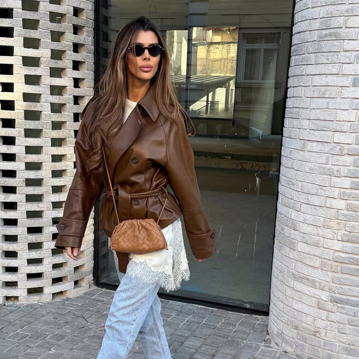 Women’s short cut oversized faux leather trench coat with waist belt and epaulettes Mune Fashion