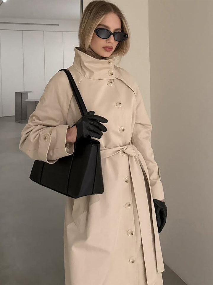 Ladies maxilength trench coat with high stand-up collar, double-breasted button placket and tie belt Mune Fashion