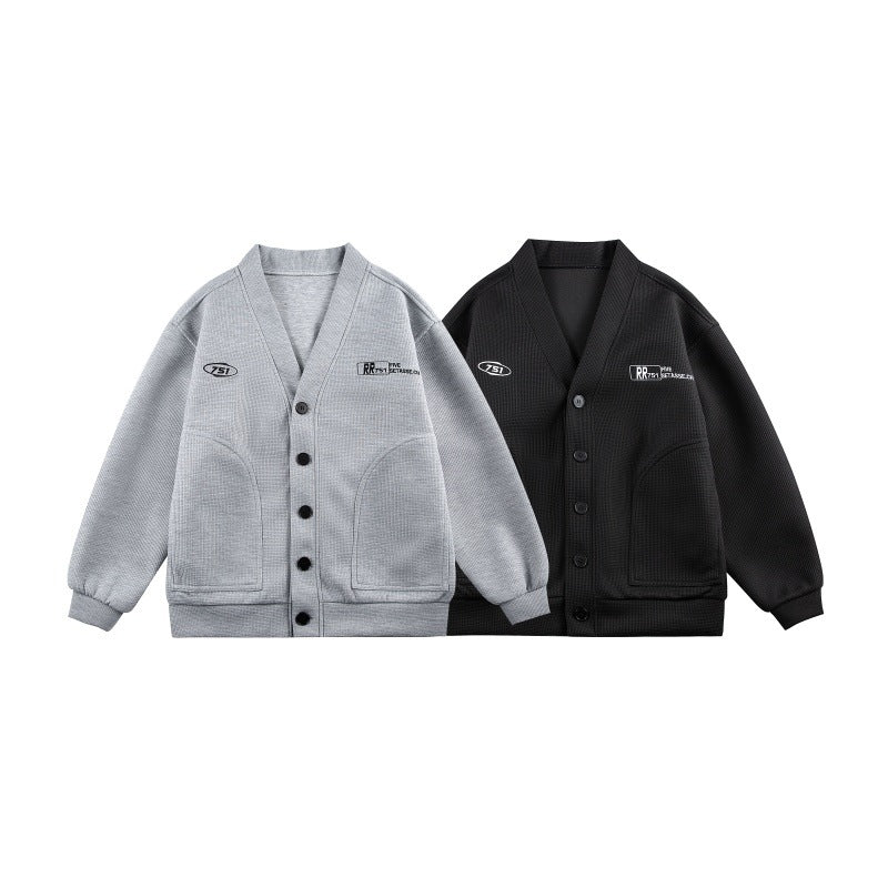 Unisex Boxy knit cardigan in waffle knit with V-neck, continuous button placket, and applied round pockets Mune Fashion