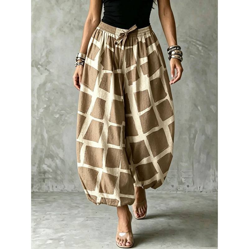 Women's wide harem pants in balloon style with elastic waistband and graphic check pattern Mune Fashion
